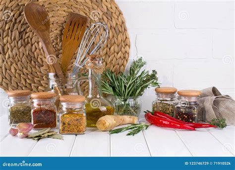 Kitchen Utensils Herbs Colorful Dry Spices In Glass Jars On White