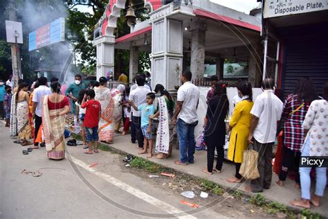 Image Of Devotees Stand In Queue Outside A Ganesh Temple To Offer