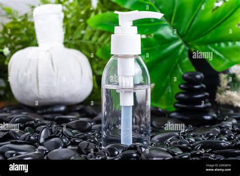 Thai Spa Massage Setting With Serum Oil Bottle Mock Up Or Essential Oil On Black Stone Against