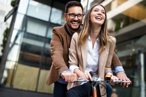 Happy Young Couple Going For A Bike Ride Young Couple Having Fun In