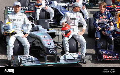 L R German Formula One Drivers Nico Rosberg And Michael Schumacher Of