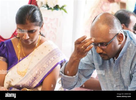 Man Applying Tilaka By Woman Sitting During Ceremony Stock Photo - Alamy