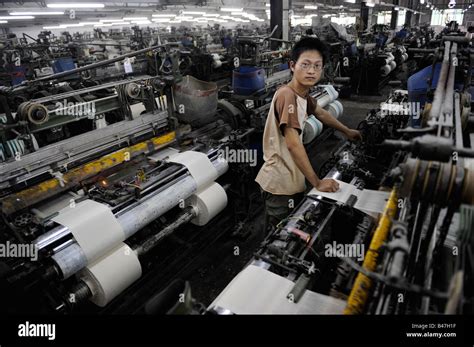 Young Worker Operating Machine At A Textile Factory In Dongguan