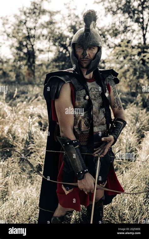 Ancient Spartan Warrior Archer In Battle Dress And Black Cloak Stands