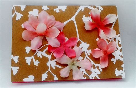 Some Pink Flowers On A Brown And White Paper