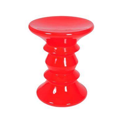 A Red Stool That Is Sitting On The Ground