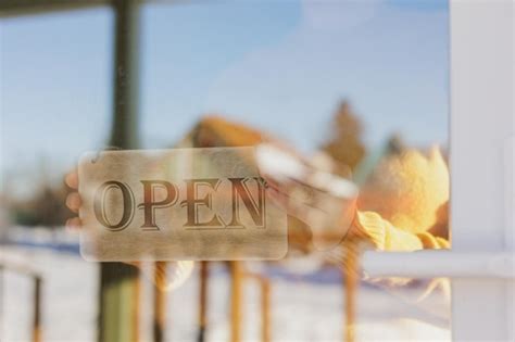 Premium Photo Wooden Sign With Inscription Open At Glass Entrance