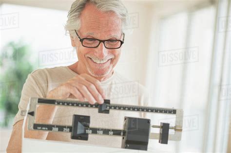 Senior Man On Weight Scale Stock Photo Dissolve