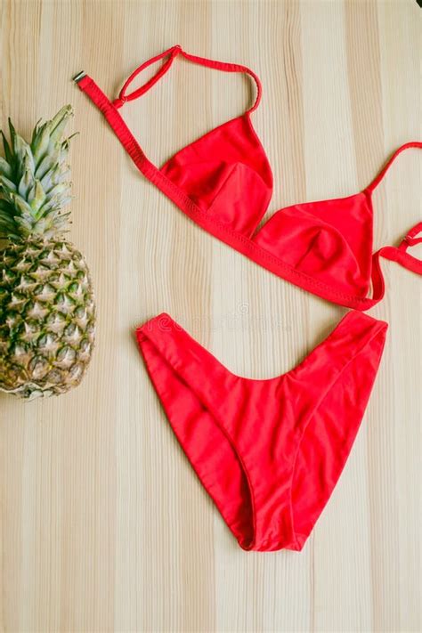 Bright Trendy Bikini On A Wooden Background With Pineapple Fashionable