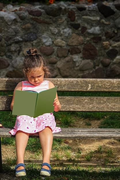 Premium Photo Full Length Of Cute Girl Reading Book While Sitting On