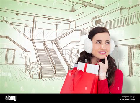 Composite Image Of Brunette With Ear Muffs Holding Shopping Bag Full Of