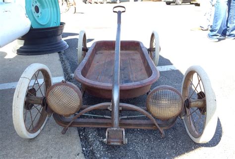 An Old Fashioned Wooden Cart Sitting On The Ground