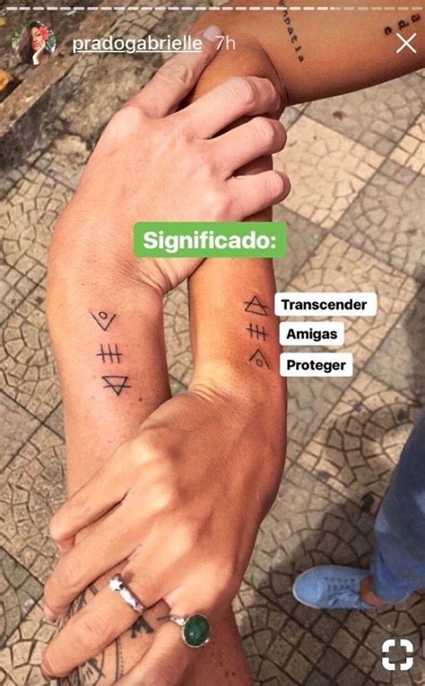 Two People Holding Hands With Tattoos On Their Arms And The Caption