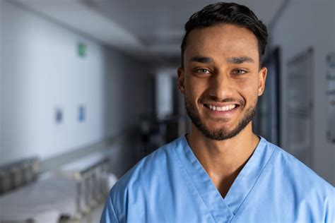 Premium Photo Portrait Of Happy Biracial Male Doctor Wearing Scrubs