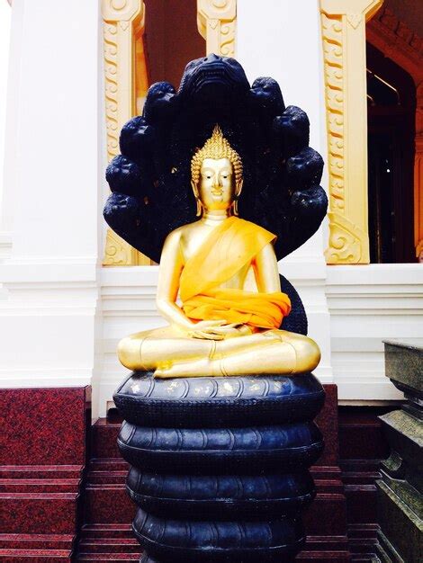 Premium Photo Buddha Statue Sitting On Snake In Temple