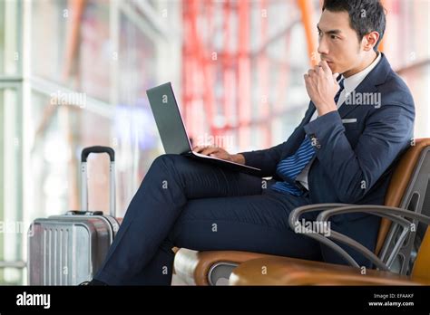 Young Businessman Using Laptop In Airport Stock Photo Alamy