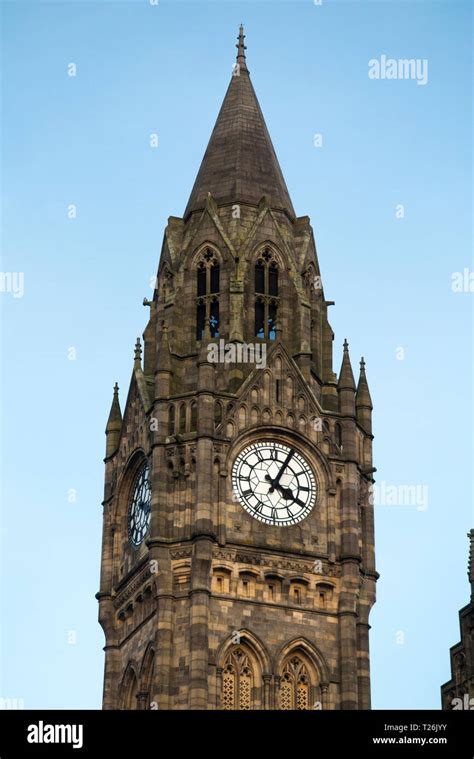 Rochdale town Hall tower clock with blue sky and late afternoon sun ...