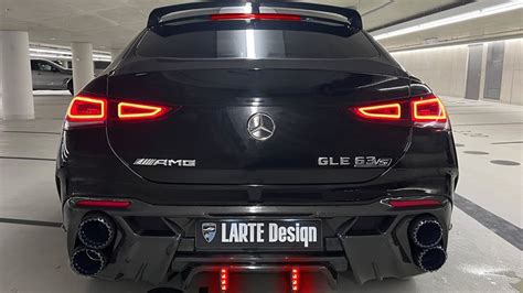 The Rear End Of A Black Car In A Parking Garage