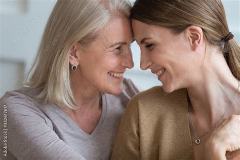 Happy Older Mother And Adult Daughter Touching Foreheads Close Up Two