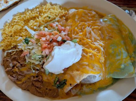 Combo Mexican Food Plate Of Burrito Quesadilla Beans And Rice Topped