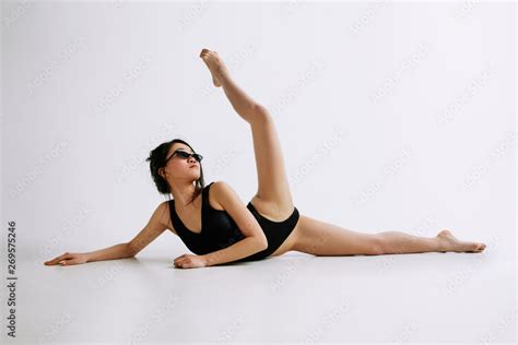 Fashion Ballet Young Female Ballet Dancer In Black Bodysuit Against