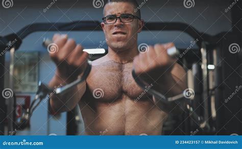 Muscular Man Workout In Gym Doing Exercises For Chest Cable Crossover