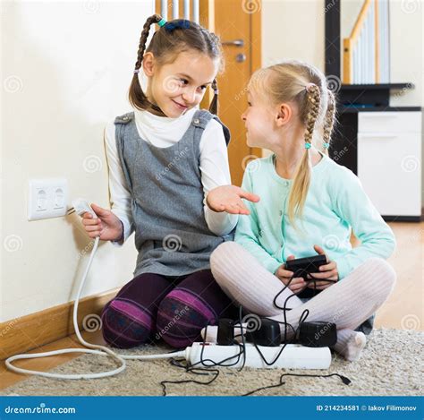 Children Playing With Sockets And Electricity Indoors Stock Image