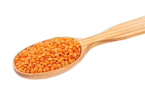 Premium Photo Red Lentils In Wooden Spoon Isolated On White