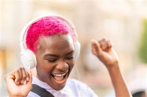 Premium Photo African Woman Dancing While Listening To Music Outdoors