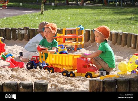 Children Playing In Sand Pit High Resolution Stock Photography And