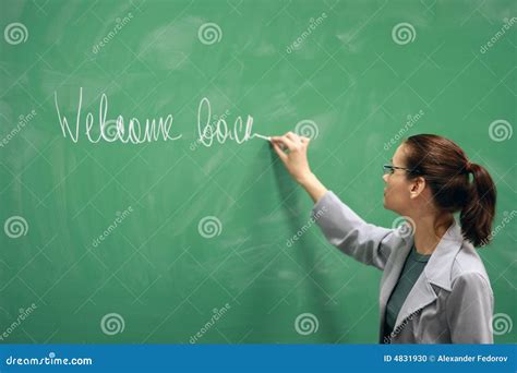 Young Teacher Writing On The Board Stock Photo - Image of candid ...