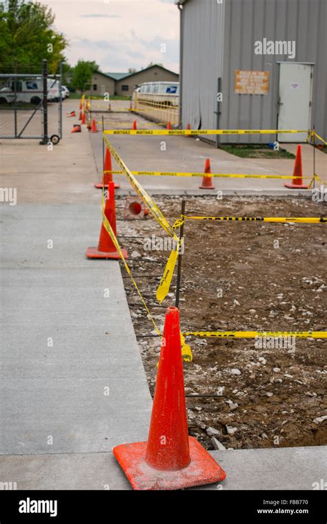Safety Orange Road Cones And Caution Tape Surround New Construction