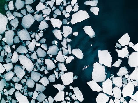 Premium Photo | Kayak sailing between ice floes on baikal lake in spring aerial drone view ...