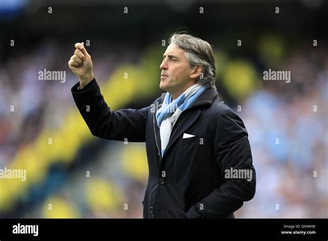 Manchester City Manager Roberto Mancini Waves An Imaginary Card Hi Res