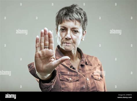 Portrait Of A Serious Mature Woman Showing Stop Gesture With Her Hand
