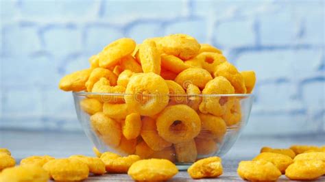 Puffed Corn Rings Chips In Black Bowl On White Background Stock Video