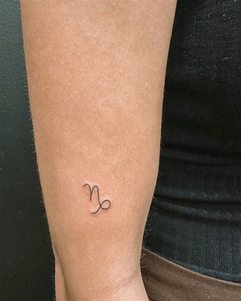 Minimalistic Style Capricorn Symbol Tattooed On The