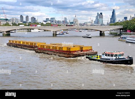 London, England, UK. Containers being transported down the Thames on ...