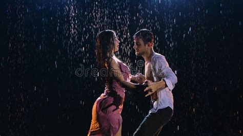 Happy Lovers Perform A Dance Of Passion In The Rain And Enjoy Each