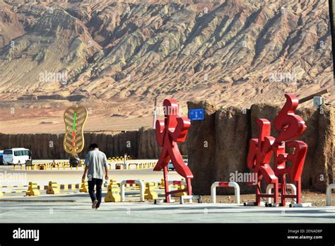 Tourists Pose For Photos With The Landmark Sculpture At The Foot Of The