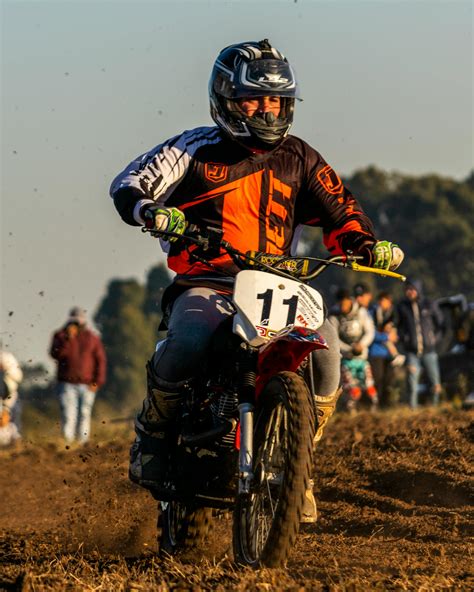 Man In Red And Black Motorcycle Suit Riding Motocross Dirt Bike · Free