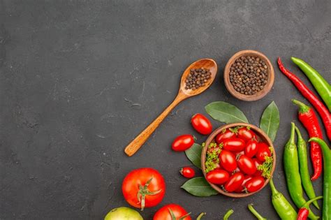 Free Photo Top View A Bowl Of Cherry Tomatoes Hot Red Peppers Black Pepper In A Wooden Spoon A
