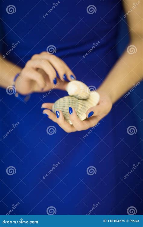 Beautiful Woman In Blue Dress Holding Some Shells In Her Hands Stock