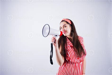 Portrait Of A Young Beautiful Woman In Red Dress Talking Into Megaphone