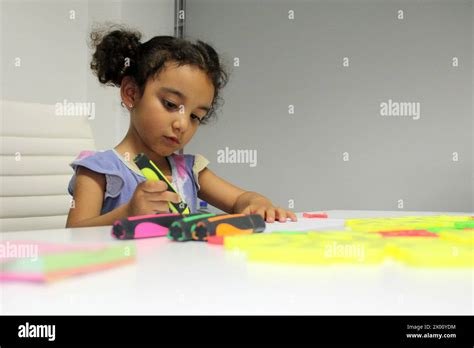 3 Year Old Latina Brunette Girl With Curly Hair Draws As Therapy For Autism And Attention