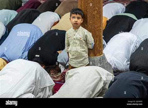 Kashmiri Muslim Boy Standing With Wooden Pillar As Muslim Worshippers