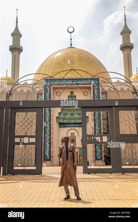 Person Traditionally Dressed Posing A Front Of Beautiful Mosque In