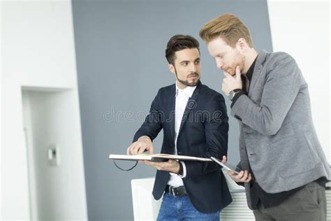 Young men in the office stock photo. Image of beard, standing - 57749224