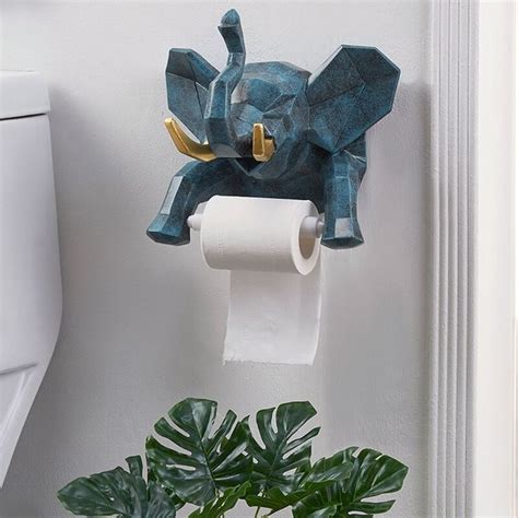 A Toilet Paper Roll Holder With An Elephant On It And A Potted Plant