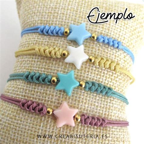 Four Bracelets With Stars On Them Are Sitting On A Burlocked Pillow